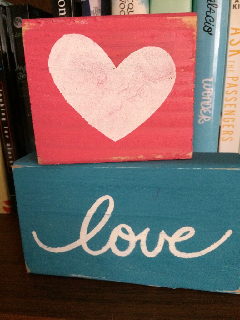 These sweet little ones sit on a bookshelf.